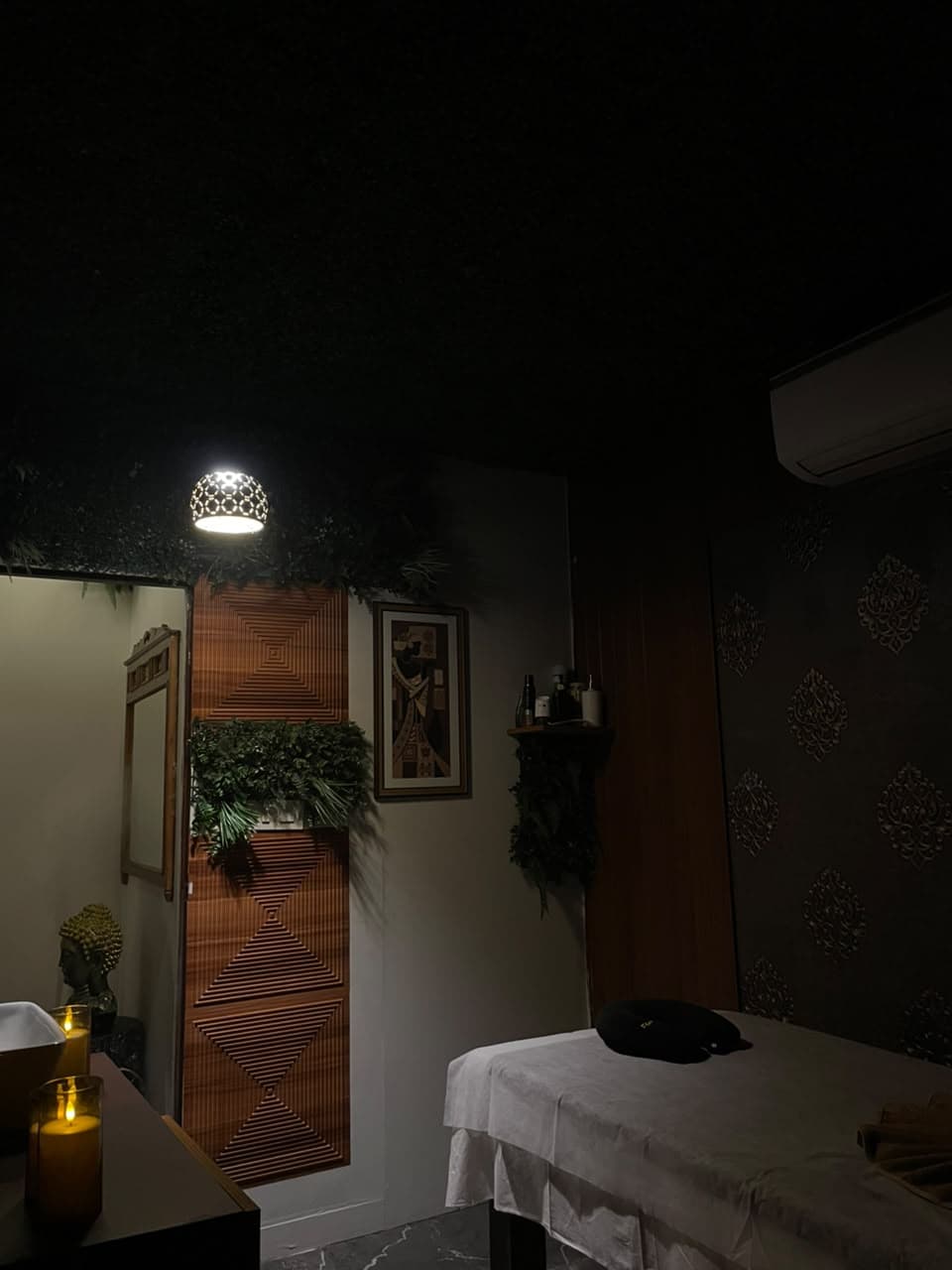Treatment room with candlelight and wooden slat wall