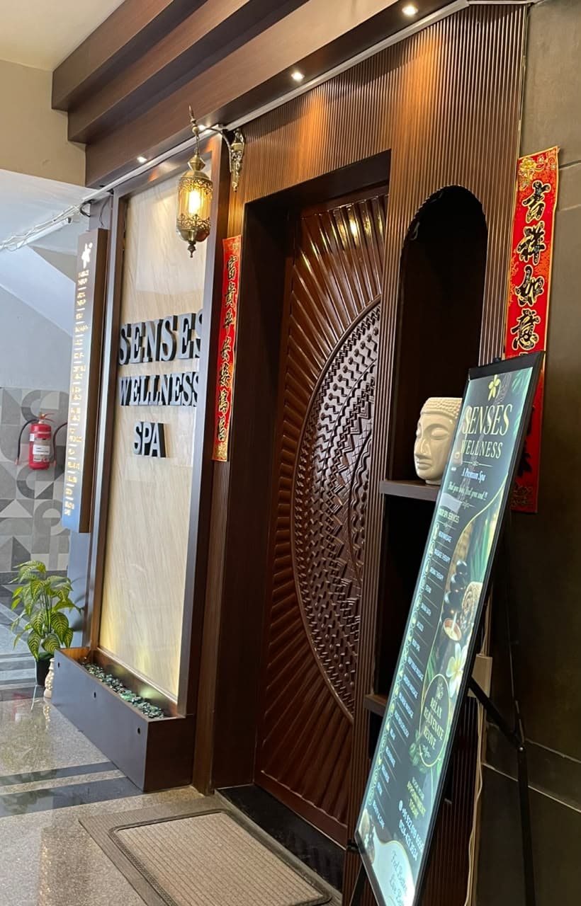 Carved wooden entrance door of Senses Wellness Spa