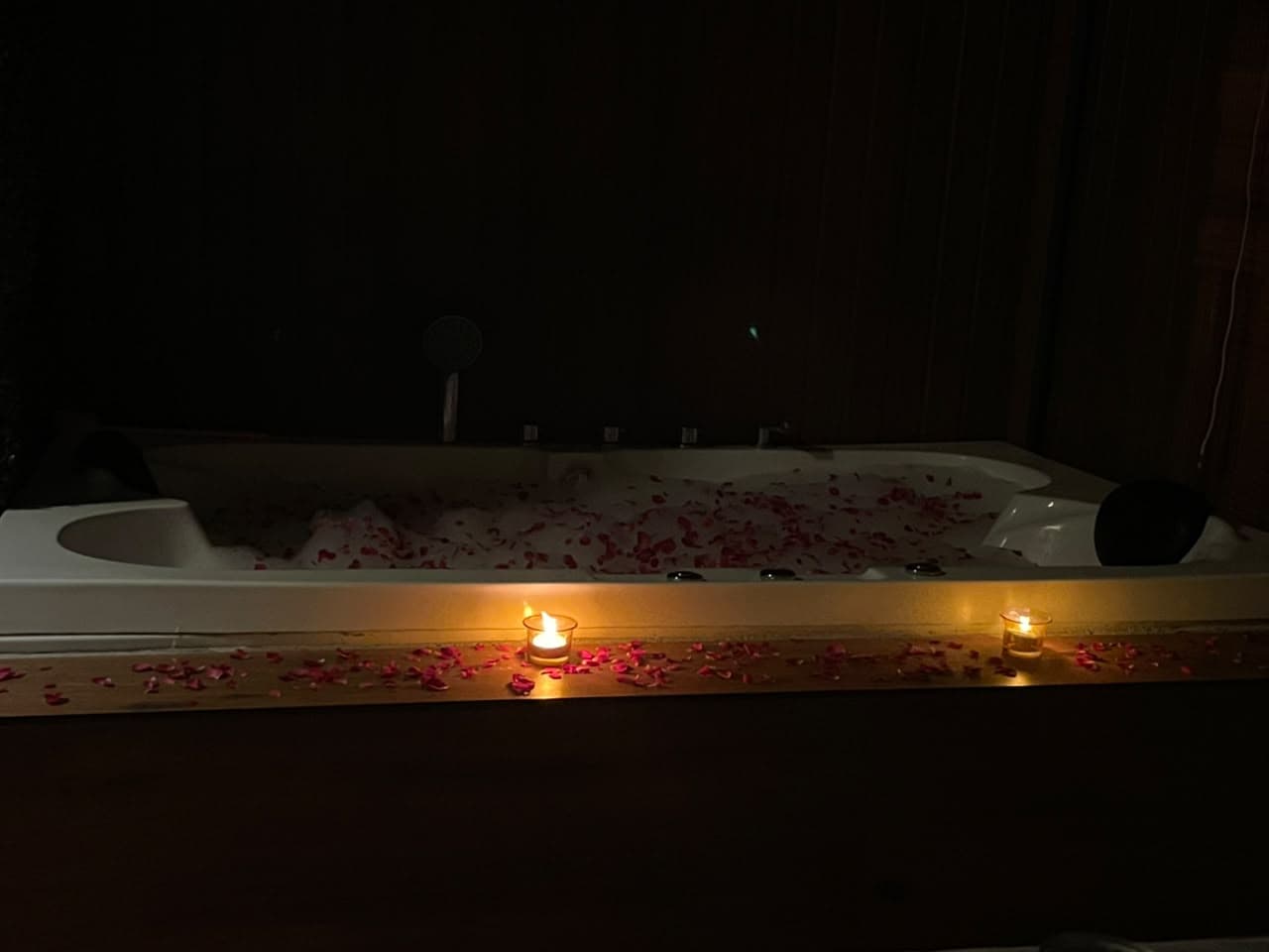 Candle-lit private Jacuzzi filled with rose petals