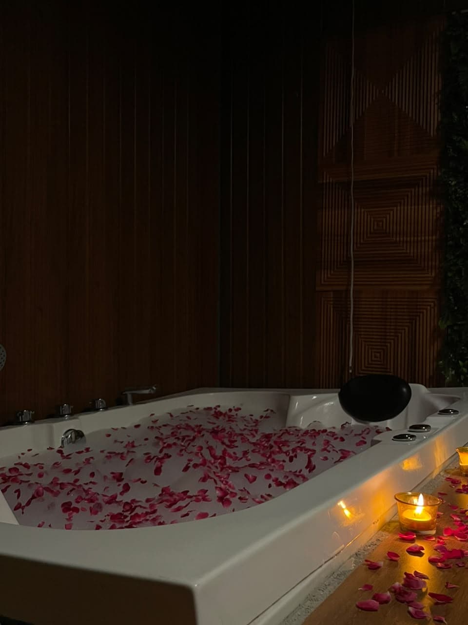 Private Jacuzzi with rose petals and candles at Senses Wellness Spa