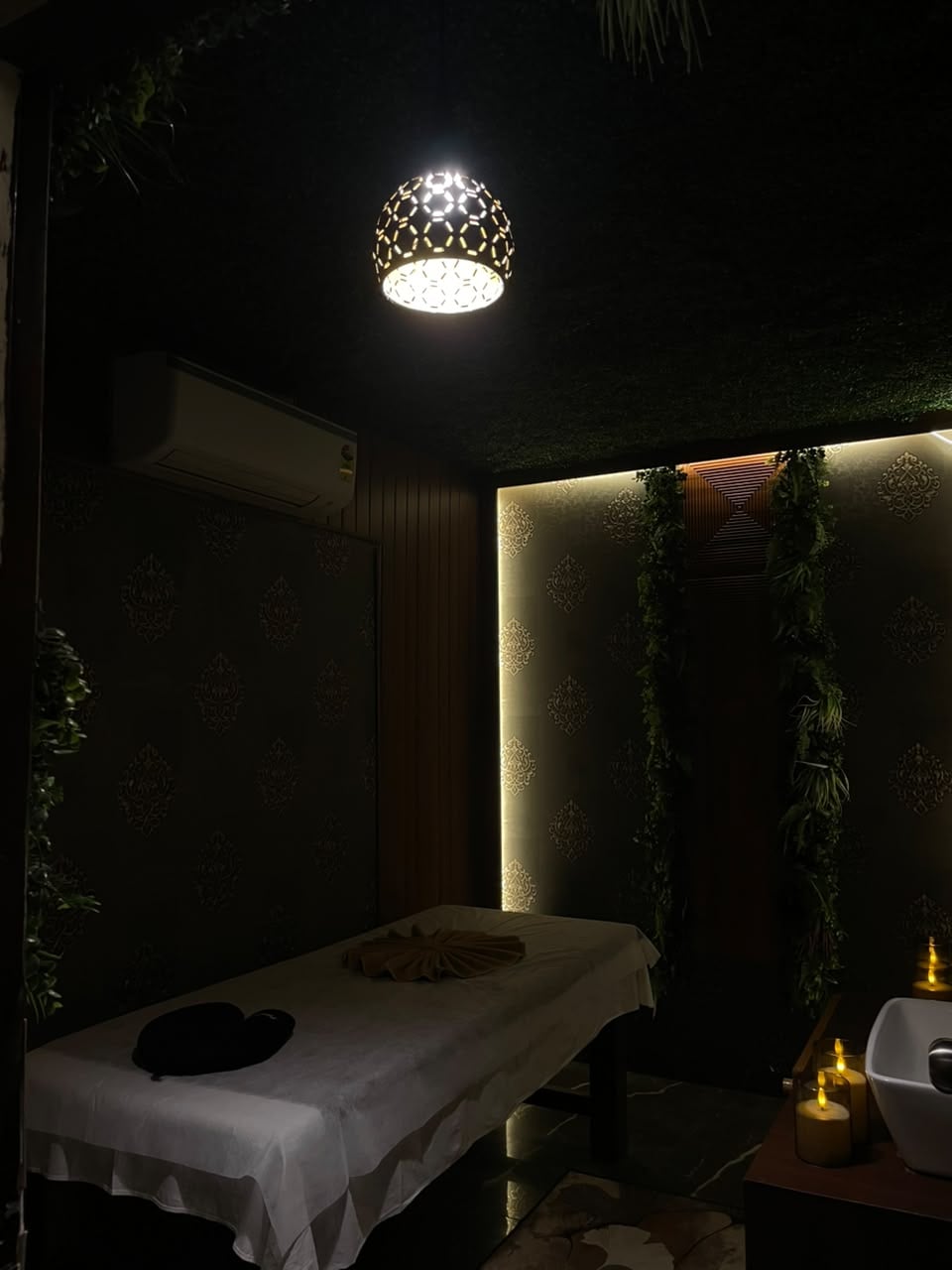 Dimly lit treatment room at Senses Wellness Spa with pendant lamp